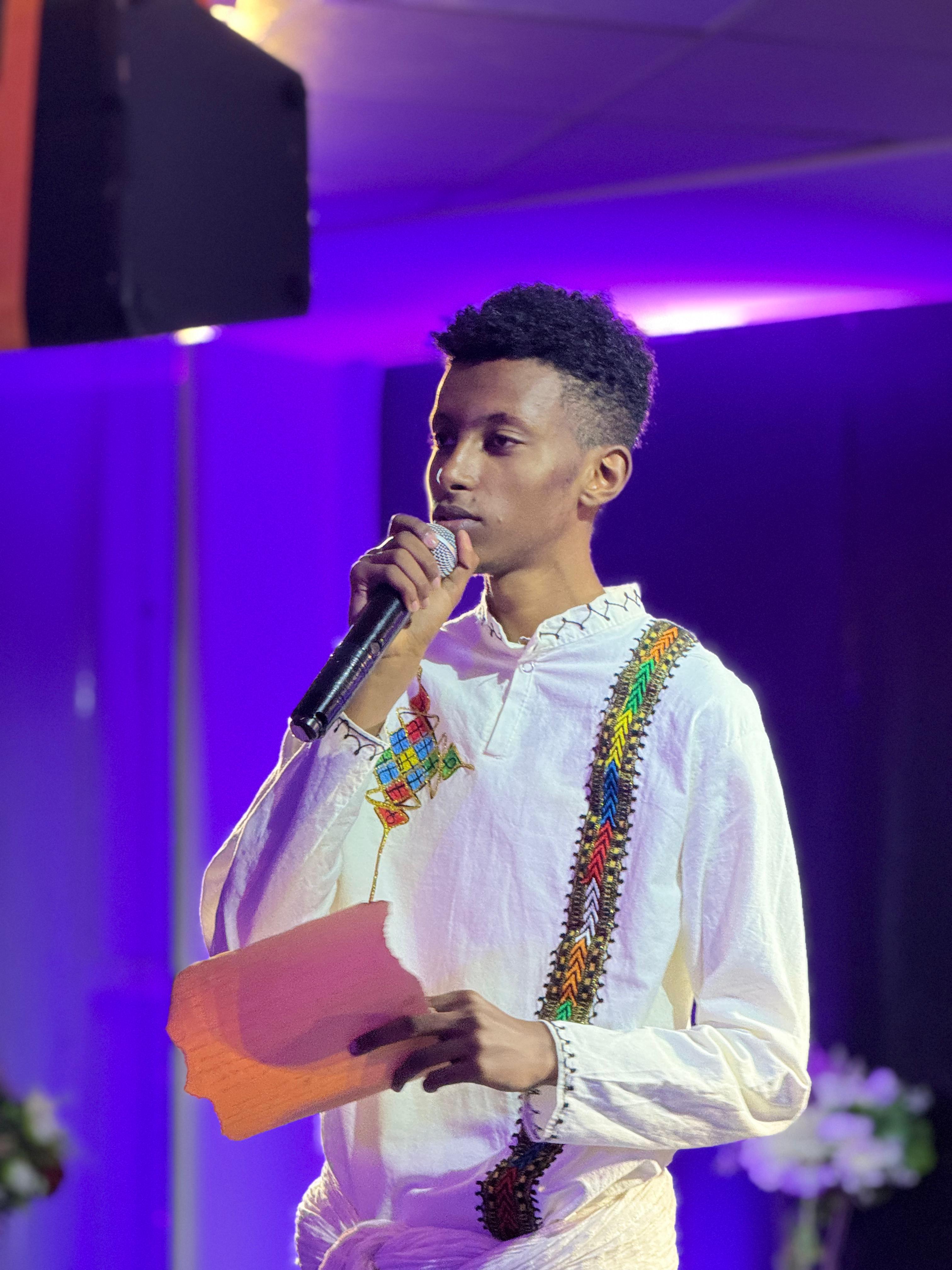 Eliyas presenting to a group, demonstrating leadership and communication skills.